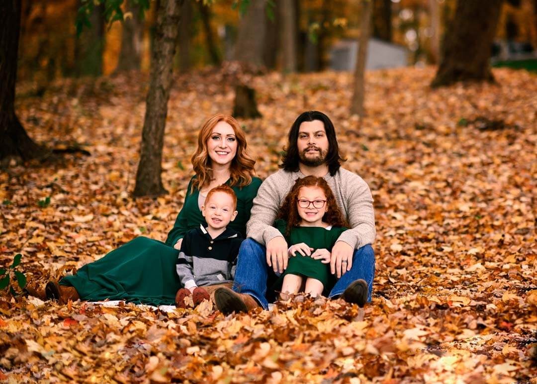 family of 4 sitting in the leafs fall session outdoors.  iris lane photography akron canton green hartville ne ohio