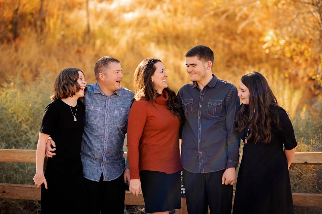 family sitting in fall leaves. Iris lane photography family photo session fall akron canton hartville ohio